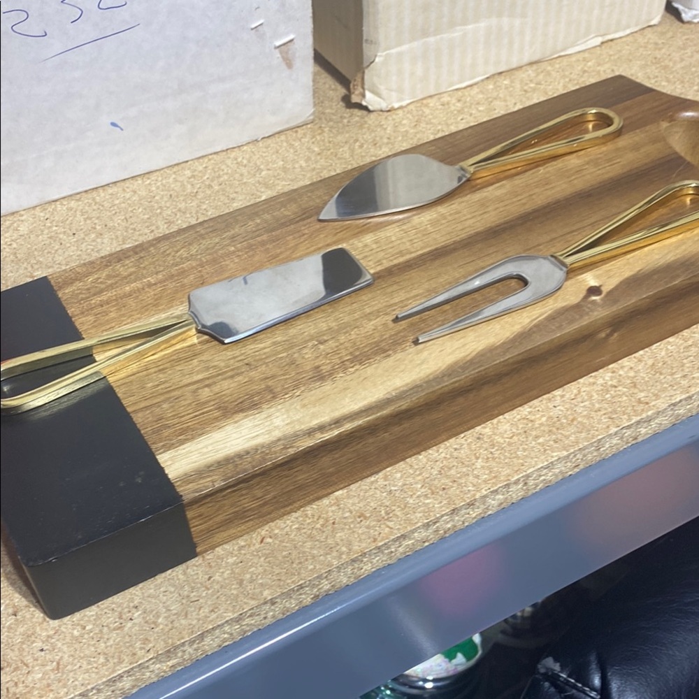 Gold and Silver Cheese Knife Set on Wooden Board